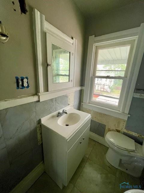 631 Clark St, Toledo, OH 43605 - half bathroom with toilet, vanity, and tile patterned flooring