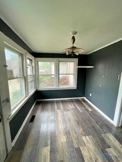 631 Clark St, Toledo, OH 43605 - unfurnished sunroom featuring wood finished floors, plenty of natural light, and ornamental molding