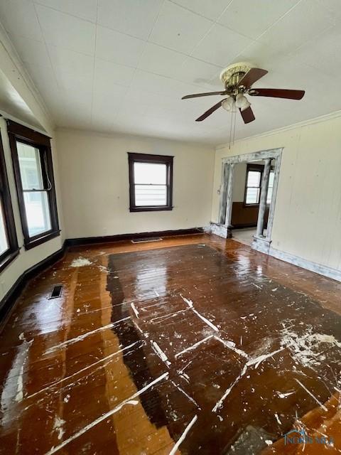 631 Clark St, Toledo, OH 43605 - unfurnished living room featuring plenty of natural light, crown molding, baseboards, and ceiling fan