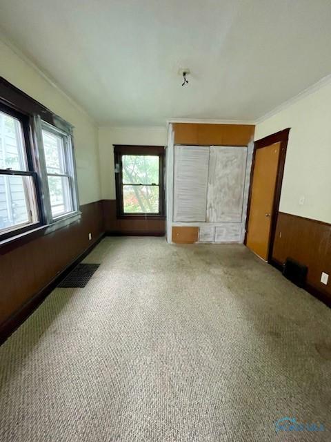 631 Clark St, Toledo, OH 43605 - unfurnished room featuring wainscoting and carpet floors