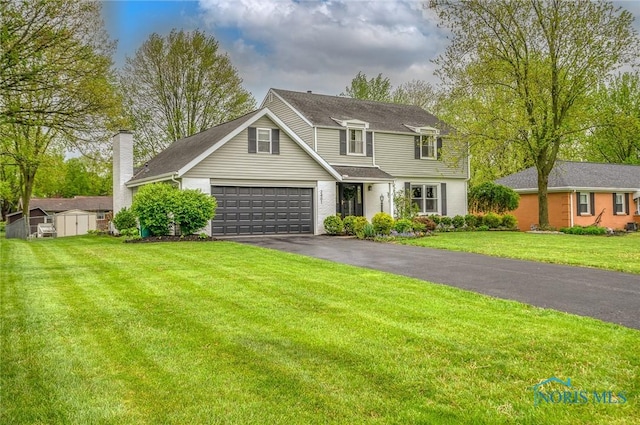traditional home featuring driveway, a chimney, an outbuilding, a front lawn, and a storage unit