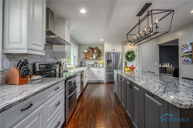 kitchen featuring open shelves, dark wood-type flooring, wall chimney exhaust hood, white cabinets, and stainless steel appliances