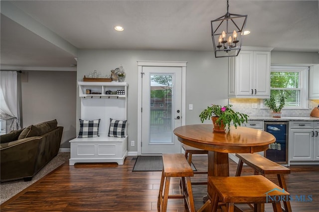 dining area with plenty of natural light, recessed lighting, dark wood-style floors, and wine cooler