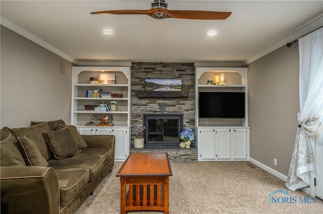 living room with crown molding, carpet floors, ceiling fan, and a fireplace