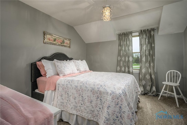 carpeted bedroom featuring baseboards and vaulted ceiling