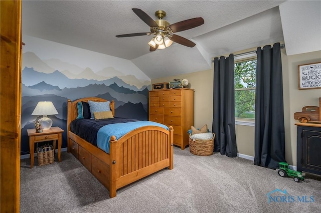 carpeted bedroom with ceiling fan, a textured ceiling, baseboards, vaulted ceiling, and a mountain view