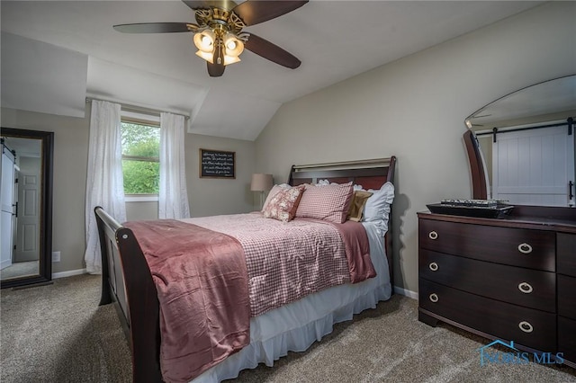 bedroom with ceiling fan, a barn door, carpet floors, baseboards, and vaulted ceiling