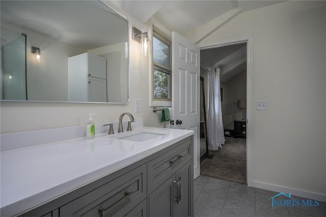 full bath with vanity, tile patterned flooring, and lofted ceiling