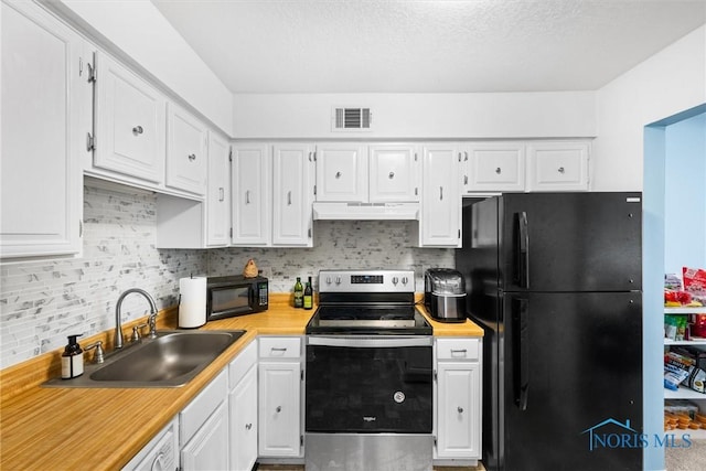 kitchen featuring visible vents, light countertops, under cabinet range hood, a sink, and black appliances