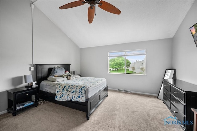 bedroom with light colored carpet, a ceiling fan, vaulted ceiling, and visible vents