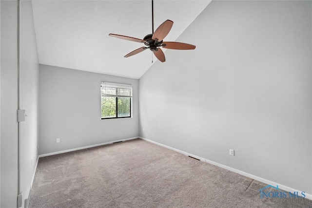 spare room with ceiling fan, carpet, baseboards, lofted ceiling, and visible vents