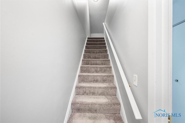 staircase featuring baseboards