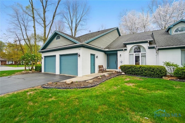 ranch-style home featuring a garage, aphalt driveway, roof with shingles, and a front yard