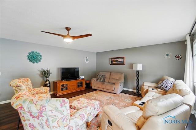living area with baseboards, ceiling fan, and wood finished floors