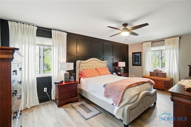 bedroom featuring light wood-style floors and ceiling fan