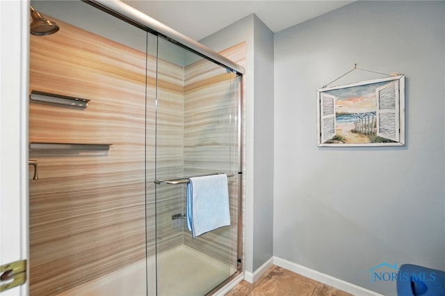 bathroom featuring baseboards and a stall shower