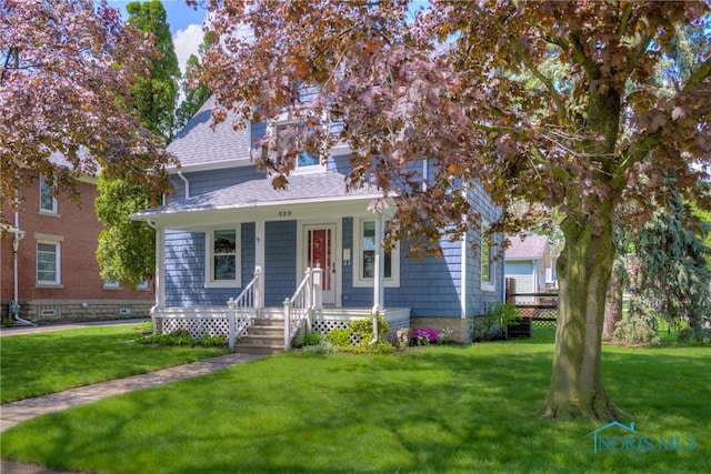 229 E Harrison St, Maumee, OH 43537 - bungalow-style home featuring a front yard, roof with shingles, and covered porch