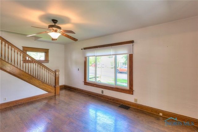 229 E Harrison St, Maumee, OH 43537 - unfurnished living room featuring stairs, wood finished floors, visible vents, ceiling fan, and baseboards