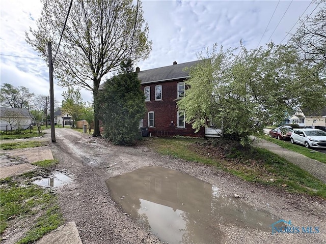364 Burger St, Toledo, OH 43605 - view of side of property featuring brick siding and a chimney