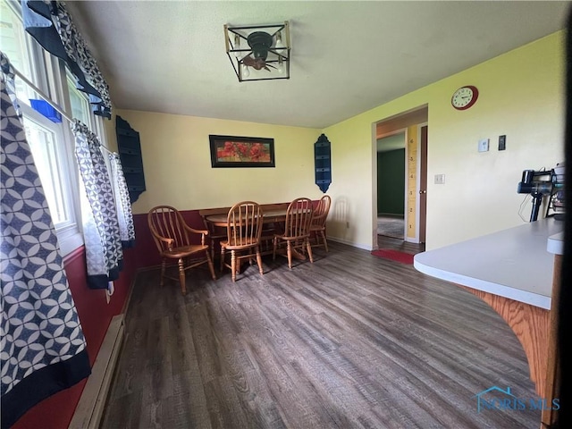 107 Oak Park Dr, Hicksville, OH 43526 - dining room with wood finished floors, a baseboard heating unit, baseboards, and ceiling fan