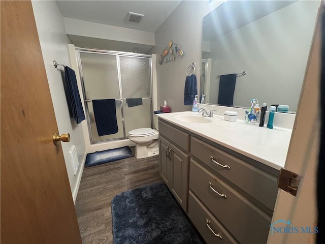 107 Oak Park Dr, Hicksville, OH 43526 - full bath with wood finished floors, vanity, a stall shower, and toilet