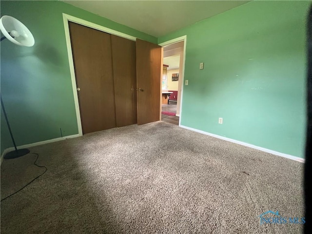 107 Oak Park Dr, Hicksville, OH 43526 - unfurnished bedroom with a closet, baseboards, and carpet floors