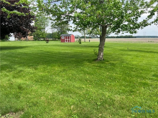 107 Oak Park Dr, Hicksville, OH 43526 - view of grassy yard with a shed and an outdoor structure