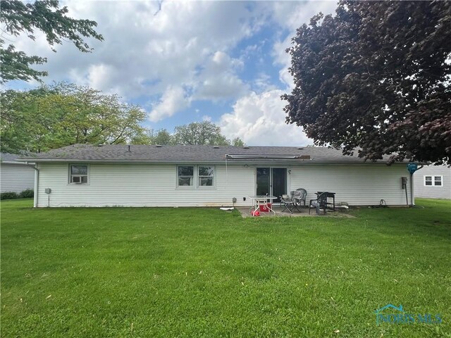 107 Oak Park Dr, Hicksville, OH 43526 - back of property with a patio and a lawn