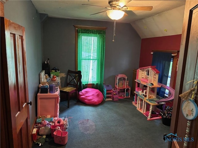 rec room featuring a ceiling fan, lofted ceiling, and carpet floors