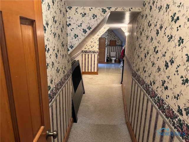 corridor featuring wallpapered walls, light carpet, and an upstairs landing