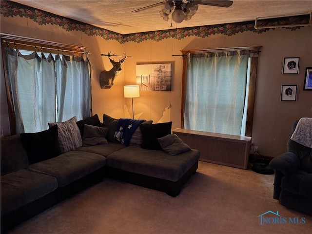 carpeted living room featuring a ceiling fan