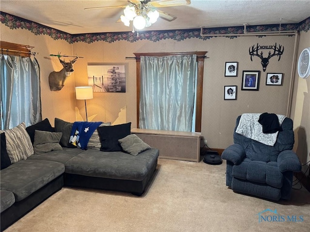 living room with a ceiling fan and carpet floors