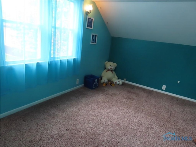 bonus room featuring carpet, vaulted ceiling, and baseboards