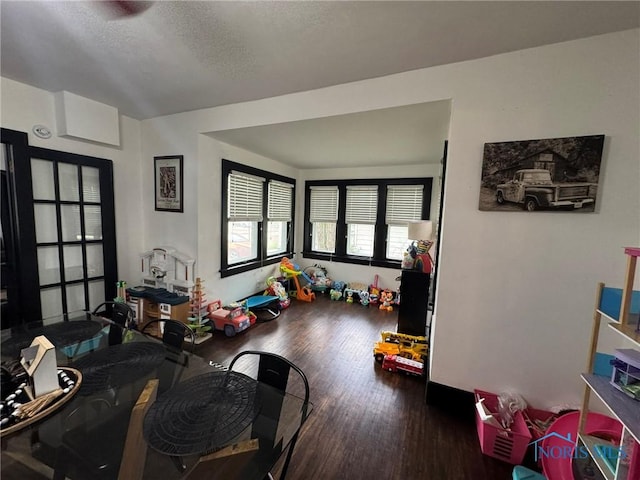 rec room with a textured ceiling and wood finished floors