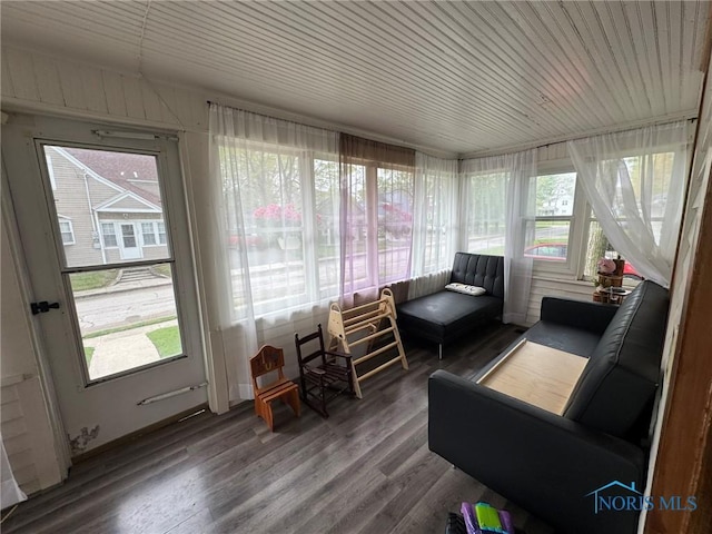 sunroom / solarium featuring plenty of natural light and wood finished floors