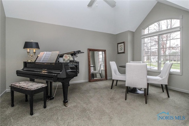 dining area with ceiling fan, lofted ceiling, carpet floors, and baseboards