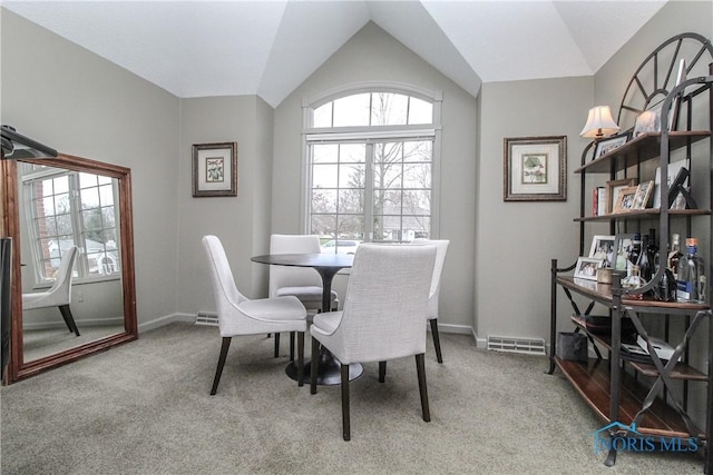 dining area with carpet flooring, visible vents, baseboards, and lofted ceiling