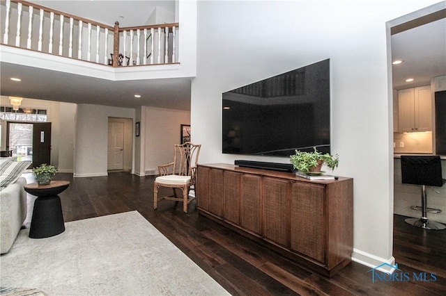 living room featuring baseboards, recessed lighting, and dark wood-style floors