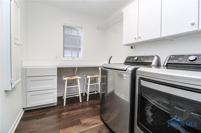 laundry room featuring cabinet space, dark wood-style floors, baseboards, and washer and dryer