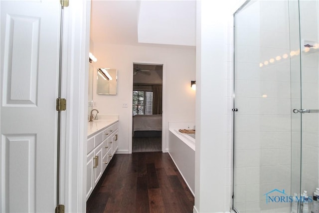 full bath featuring vanity, ensuite bathroom, a shower stall, and wood finished floors