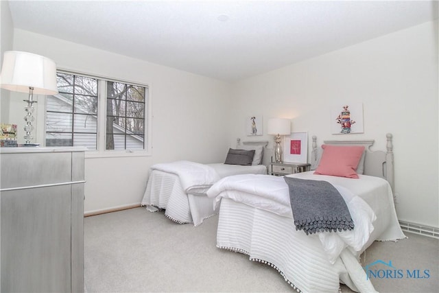 carpeted bedroom featuring baseboards