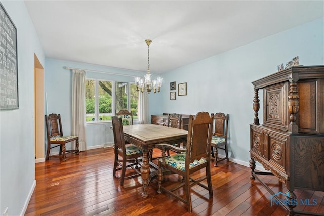 3448 Corey Rd, Toledo, OH 43615 - dining space featuring a chandelier, dark wood-style floors, and baseboards