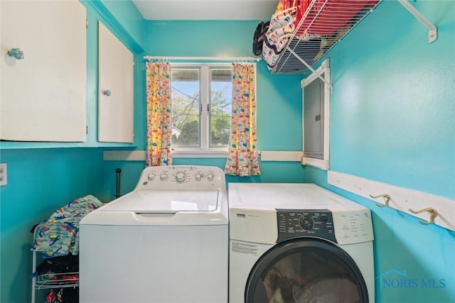 3448 Corey Rd, Toledo, OH 43615 - laundry room featuring washing machine and dryer, cabinet space, and electric panel