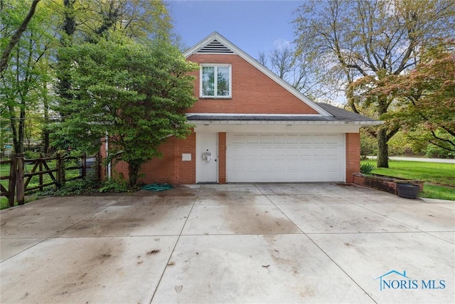 3448 Corey Rd, Toledo, OH 43615 - garage featuring concrete driveway and fence