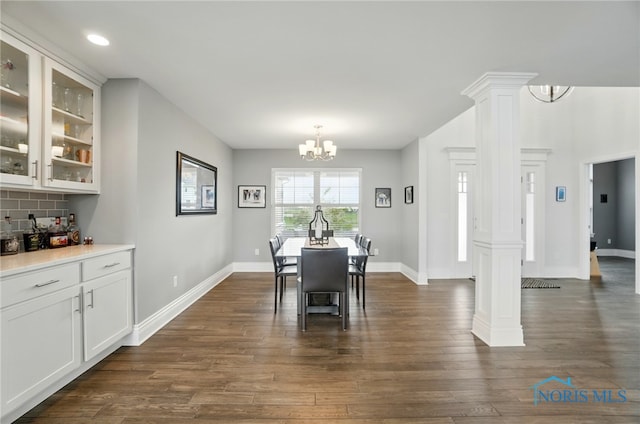 dining space featuring decorative columns, a chandelier, dark wood-style flooring, baseboards, and recessed lighting