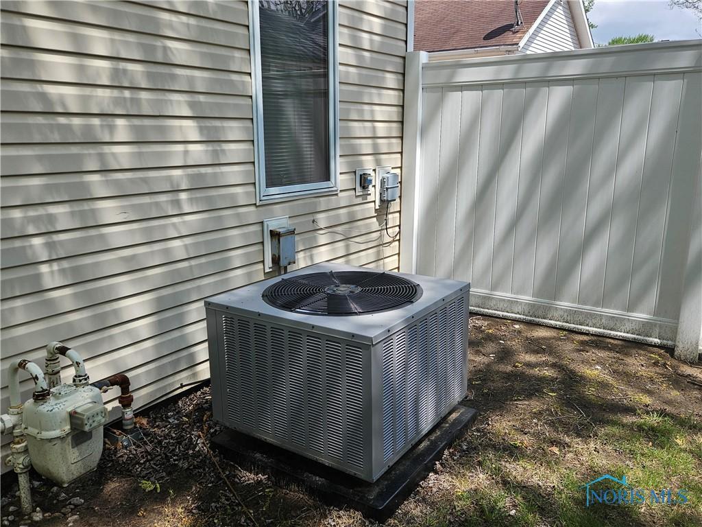 exterior details featuring gas meter and central AC