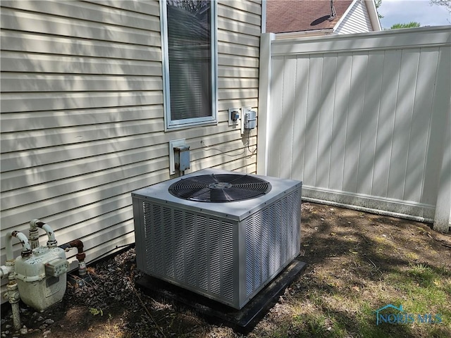 exterior details featuring gas meter and central AC