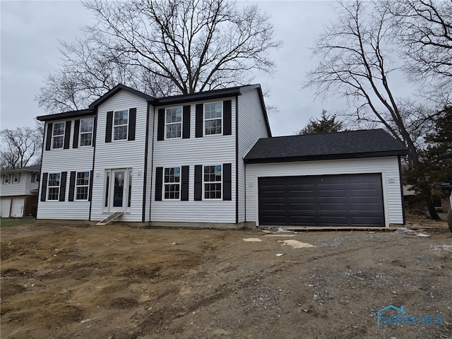 colonial house with driveway and a garage
