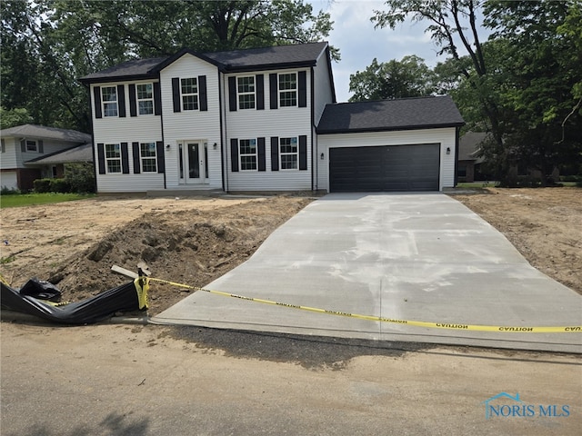 3945 Imperial Blvd, Toledo, OH 43623 - colonial home with concrete driveway and an attached garage