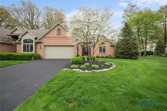 2284 Big Hickory Run, Sylvania, OH 43560 - traditional-style house with aphalt driveway, a garage, a front lawn, and brick siding